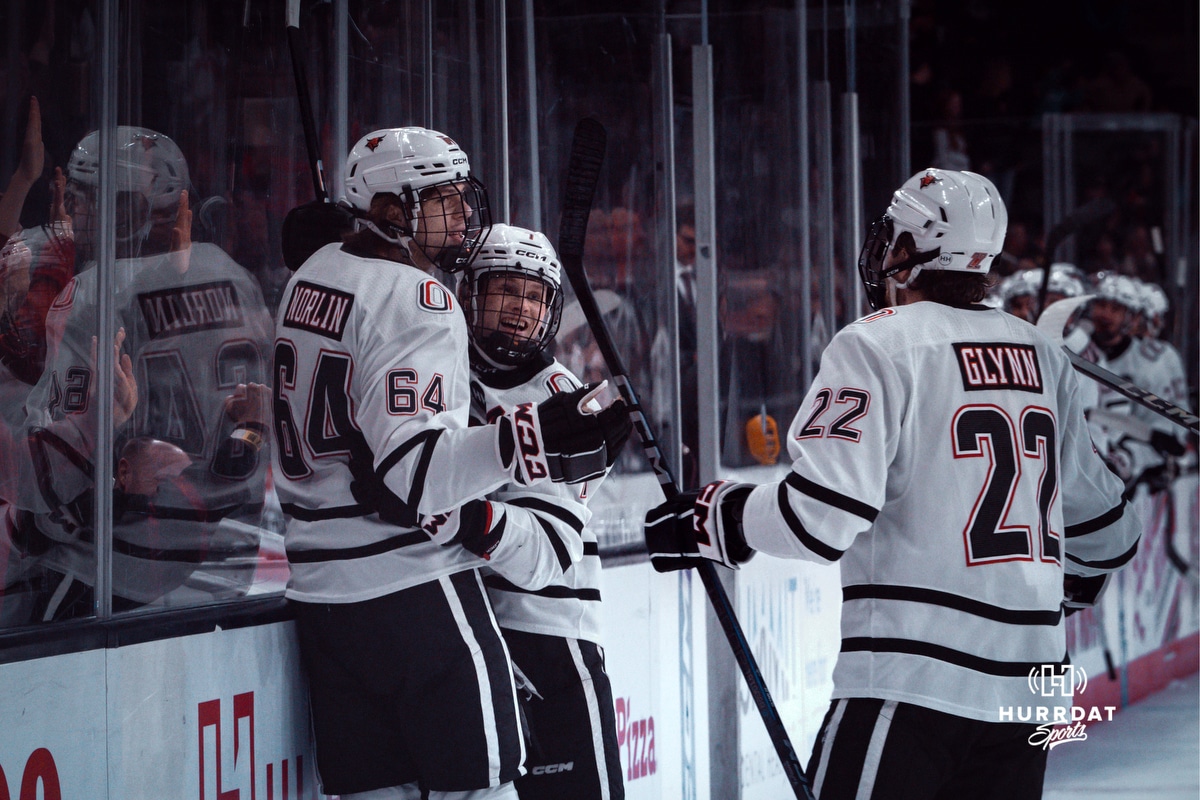 UNO Mavericks players, Jimmy Glynn, Griffin Ludtke, and Isaiah Norlin celebrate a goal during a college hockey game on Dec 29, 2024 in Omaha, Nebraska. Photo by Logan Hock