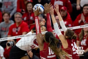 Nebraska Cornhuskers outside hitter Taylor Landfair (12) spikes the ball against Wisconsin Badgers opposite Devyn Robinson (10) in the second set during the final regional match in the NCAA championship Sunday, December 15, 2024, in Lincoln, Nebraska. Photo by John S. Peterson.