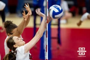 Nebraska Cornhuskers setter Bergen Reilly (2) blocks the ball against the Wisconsin Badgers in the second set during the final regional match in the NCAA championship Sunday, December 15, 2024, in Lincoln, Nebraska. Photo by John S. Peterson.