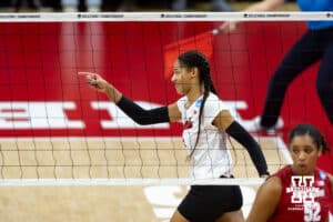 Nebraska Cornhuskers outside hitter Taylor Landfair (12) celebrates pointing to Bergen Reilly for the set against the Wisconsin Badgers in the secodn set during the final regional match in the NCAA championship Sunday, December 15, 2024, in Lincoln, Nebraska. Photo by John S. Peterson.