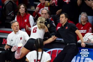 Nebraska Cornhuskers assistant Jaylen Reyes tries to save Laney Choboy from getting hurt going after a ball against the Wisconsin Badgers during the final regional match in the NCAA championship Sunday, December 15, 2024, in Lincoln, Nebraska. Photo by John S. Peterson.