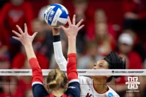 Nebraska Cornhuskers outside hitter Harper Murray (27) spikes the ball against Dayton Flyers outside hitter Brooke Smith (1) during the first regional match in the NCAA championship Friday, December 13, 2024, in Lincoln, Nebraska. Photo by John S. Peterson.