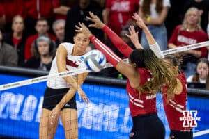 Nebraska Cornhuskers outside hitter Merritt Beason (13) spike the ball past Wisconsin Badgers opposite Devyn Robinson (10) in the third set during the final regional match in the NCAA championship Sunday, December 15, 2024, in Lincoln, Nebraska. Photo by John S. Peterson.