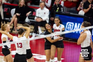 Nebraska Cornhuskers outside hitter Harper Murray (27) gets a hug from Lexi Rodriguez after scoring a point against the Wisconsin Badgers in the third set during the final regional match in the NCAA championship Sunday, December 15, 2024, in Lincoln, Nebraska. Photo by John S. Peterson.