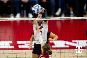 Nebraska Cornhuskers outside hitter Harper Murray (27) blocks the ball against Wisconsin Badgers setter Charlie Fuerbringer (24) in the third set during the final regional match in the NCAA championship Sunday, December 15, 2024, in Lincoln, Nebraska. Photo by John S. Peterson.