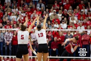 Nebraska Cornhuskers middle blocker Rebekah Allick (5) and Merritt Beason block the ball against the Wisconsin Badgers in the third set during the final regional match in the NCAA championship Sunday, December 15, 2024, in Lincoln, Nebraska. Photo by John S. Peterson.