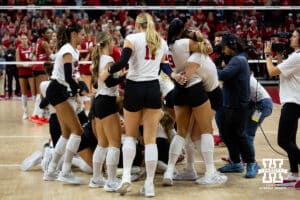 Nebraska Cornhuskers celebrate the win over the Wisconsin Badgers in the third set during the final regional match in the NCAA championship Sunday, December 15, 2024, in Lincoln, Nebraska. Photo by John S. Peterson.