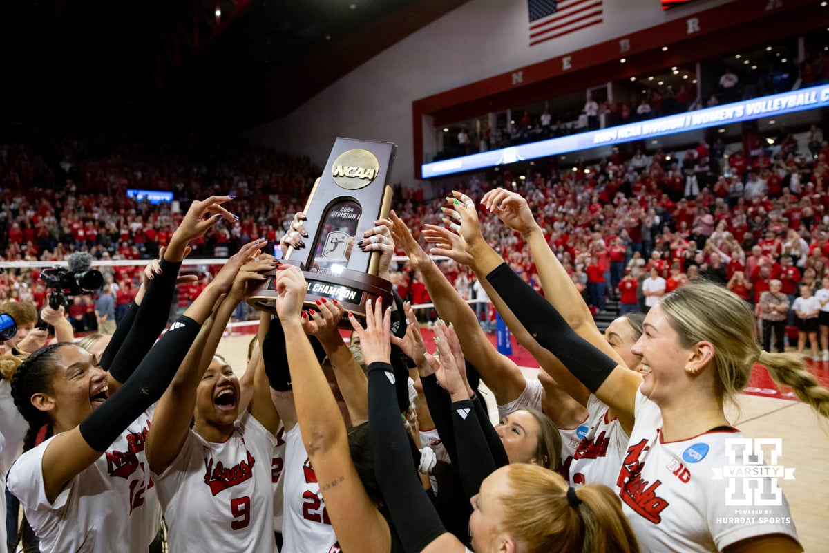 Nebraska Cornhuskers celebrate with the trophy after the win over the Wisconsin Badgers during the final regional match in the NCAA championship Sunday, December 15, 2024, in Lincoln, Nebraska. Photo by John S. Peterson.