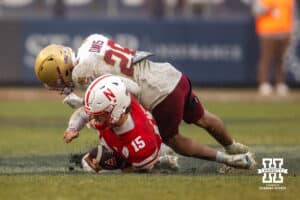 Nebraska Cornhuskers quarterback Dylan Raiola (15) takes a hit when sliding by Boston College Eagles defensive back Carter Davis (28) during the Pinstripe Bowl game, Saturday, December 28, 2024, in New York, New York. Photo by John S. Peterson.