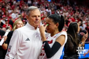 Nebraska Cornhuskers Harper Murray (27) and coach John Cook hug after the win over Wisconsin during the regional match in the NCAA championship Sunday, December 15, 2024, in Lincoln, Nebraska. Photo by John S. Peterson.