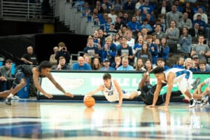 Creighton Bluejays Mason Miller (13) dives for a loose ball during a college basketball game against the Villanova Wildcats on Saturday, December 21st, 2024 in Omaha Nebraska. Photo by Brandon Tiedemann.