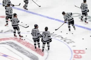 The team goes through warmups during a hockey match at Baxter Arena on Saturday, December 14, 2024, in Omaha, Nebraska. Photo by Collin Stilen.