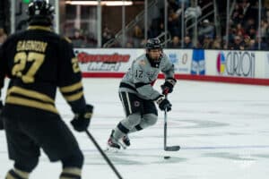 Captain defenseman, Nolan Krenzen, looking for a pass during a hockey match at Baxter Arena on Saturday, December 14, 2024, in Omaha, Nebraska. Photo by Collin Stilen.