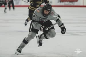 Forward, Zach Urdahl, goes after the puck during a hockey match at Baxter Arena on Saturday, December 14, 2024, in Omaha, Nebraska. Photo by Collin Stilen.