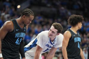 Creighton's Ryan Kalkbrenner (11) speaks with Villanova's Eric Dixon (43). The two combined for 50 points in the Creighton win. Photo by Brandon Tiedemann.