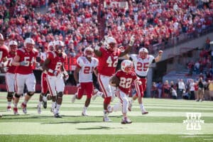 Seven year old Cornhusker Jack Hoffman (22) runs with the ball to score a touchdown in the fourth quarter for the Red team Saturday, April 6, 2013, at Memorial Stadium in Lincoln, Nebraska. Photo John S. Peterson.