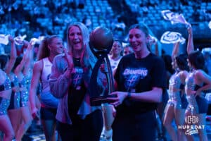 Gina Mancuso-Prososki and Jess Schaben-Lansman carry the 2024 Championship trophy out for the banner drop celebrates before the match against the Atlanta Vibe Friday, January 10, 2025, in Omaha, Nebraska. Photo by John S. Peterson.