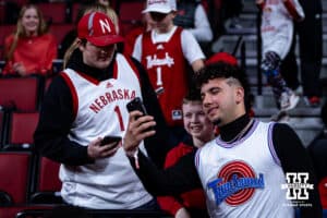 Nebraska Cornhuskers quarterback Dylan Raiola takes a selfie with fans before a college basketball game against the USC Trojans, Wednesday, January 22, 2025, in Lincoln, Nebraska. Photo by John S. Peterson.