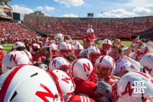 Nebraska Cornhusker quarterback Taylor Martinez #3 and Jack Hoffman #22 are surrounded by the Huskers after Jack scored a touchdown for the Red team during the Red-White spring game at Memorial Stadium in Lincoln, Nebraska. Photo by John S. Peterson.