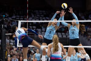 Omaha Supernovas outside hitter Reagan Cooper (8) spikes the ball against Atlanta Vibe opposite hitter Merritt Beason (5) and middle blocker McKenna Vicini (12) in the first set during a professional volleyball match, Friday, January 10, 2025, in Omaha, Nebraska. Photo by John S. Peterson.