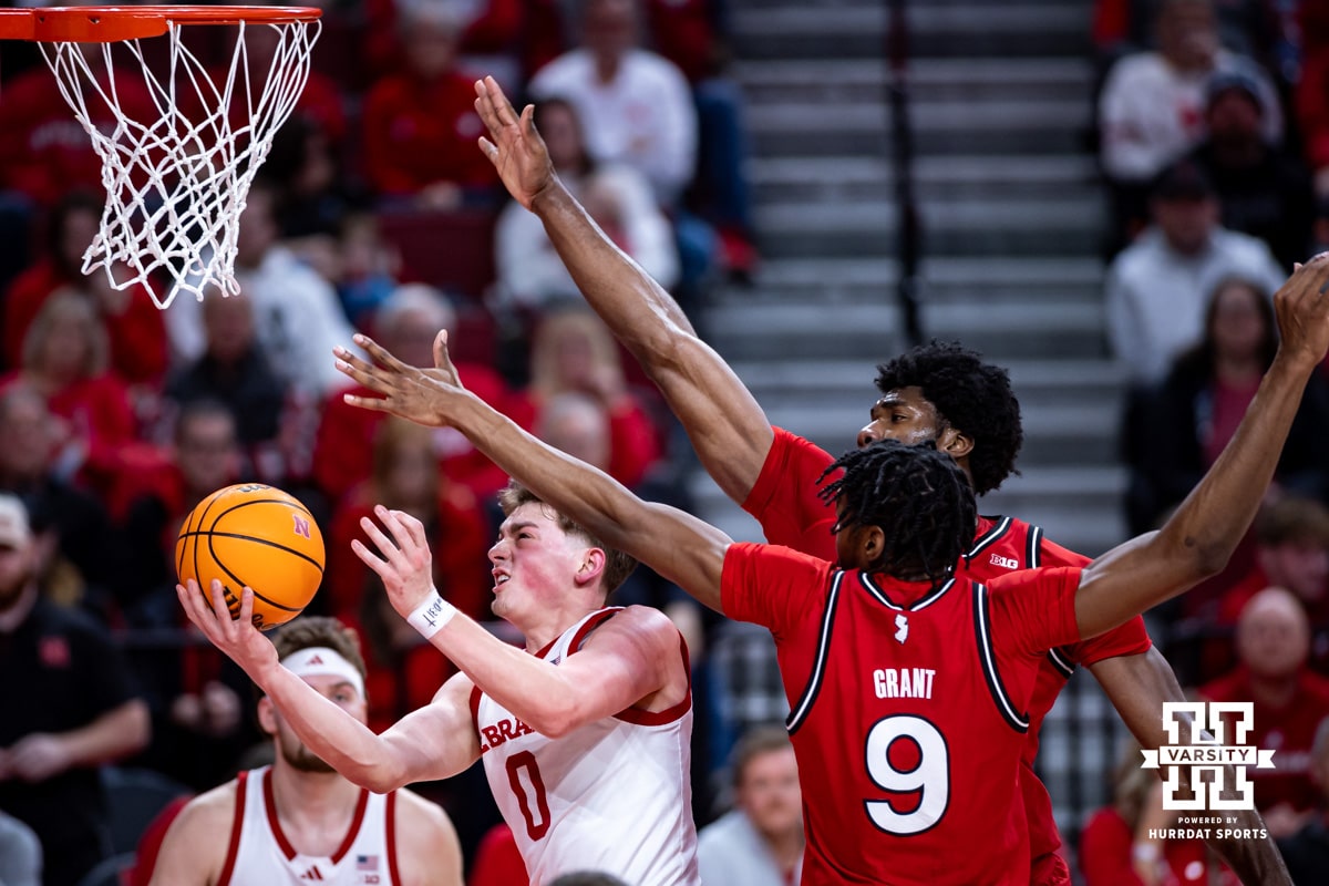 Nebraska Cornhuskers guard Connor Essegian (0) drives to the basket against Rutgers Scarlet Knights forward Dylan Grant (9) in the first half during a college basketball game, Thursday, January 16, 2025, in Lincoln, Nebraska. Photo by John S. Peterson.