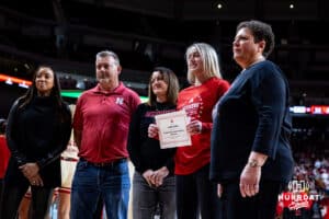 Nebraska Cornhuskers guard Allison Weidner award a scholarship with her parents during a college basketball game against the Ohio State Buckeyes, Sunday, January 26, 2025, in Lincoln, Nebraska. Photo by John S. Peterson.