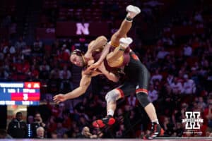 #22 Nebraska Cornhusker Camden McDanel throws #9 Minnesota Golden Gopher Isaiah Salazar during a college wrestling match, Saturday, January 11, 2025, in Lincoln, Nebraska. Salazar defeats McDanel 8-0. Photo by John S. Peterson.