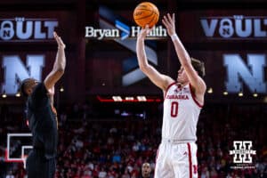 Nebraska Cornhuskers guard Connor Essegian (0) makes a three-point shot against USC Trojans guard Chibuzo Agbo (7) in the first half during a college basketball game, Wednesday, January 22, 2025, in Lincoln, Nebraska. Photo by John S. Peterson.