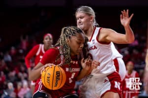 Nebraska Cornhuskers forward Jessica Petrie (12) draws a charging call against Wisconsin Badgers center Carter McCray (1) during a college basketball game, Monday, January 20, 2025, in Lincoln, Nebraska. Photo by John S. Peterson.