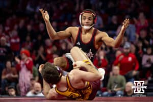 #7 Nebraska Cornhusker Caleb Smith celebrates the upset against #5 Minnesota Golden Gopher Cooper Flynn during a college wrestling match, Saturday, January 11, 2025, in Lincoln, Nebraska. Smith upsets Flynn 2-0. Photo by John S. Peterson.