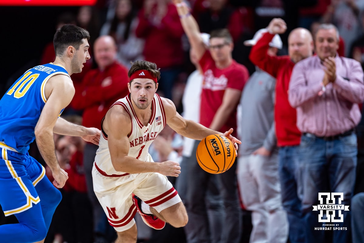 Nebraska Cornhuskers guard Sam Hoiberg (1) dribbles the ball to use up time at the end of the second half against UCLA Bruins guard Lazar Stefanovic (10) during college basketball game, Saturday, January 4, 2024, in Lincoln, Nebraska. Photo by John S. Peterson.