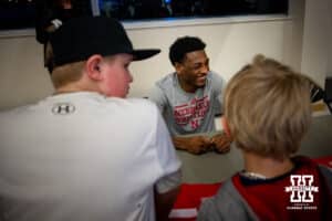 Nebraska's Antrell Taylor siles as he talks with fans and signs autographs after the match against Penn State, Friday, January 17, 2025, in Lincoln, Nebraska. Photo by John S. Peterson.