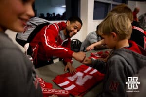 Nebraska's Caleb Smith give a young fan a fist bump as he talks with fans and signs autographs after the match against Penn State, Friday, January 17, 2025, in Lincoln, Nebraska. Photo by John S. Peterson.