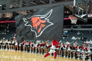 Omaha Mavericks Durango running with a flag before a college basketball game against Kansas City on January 8th, 2025 in Omaha Nebraska. Photo by Brandon Tiedemann.