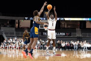 Omaha Mavericks JJ White shoots a contested three pointer during a college basketball game against Kansas City on January 8th, 2025 in Omaha Nebraska. Photo by Brandon Tiedemann.