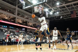 Omaha Mavericks JJ White slips past a defender and attempts a layup during a college basketball game against Kansas City on January 8th, 2025 in Omaha Nebraska. Photo by Brandon Tiedemann.