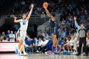 Creighton Bluejays Isaac Traudt contests a shot during a college basketball game against Xavier on January 29th, 2025 in Omaha Nebraska. Photo by Brandon Tiedemann.