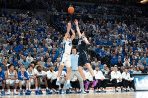 Creighton Bluejays Isaac Traudt shoots a heavily contested shot during a college basketball game against Xavier on January 29th, 2025 in Omaha Nebraska. Photo by Brandon Tiedemann.