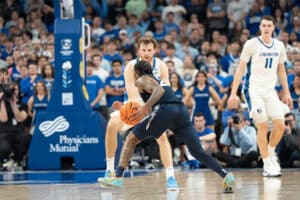 Creighton Bluejays Isaac Traudt defends during a college basketball game against Xavier on January 29th, 2025 in Omaha Nebraska. Photo by Brandon Tiedemann.