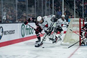 Omaha Maverick Jimmy Glynn battling for the puck during a hockey match at Baxter Arena on Saturday, January 25, 2025, in Omaha, Nebraska. Photo by Collin Stilen.