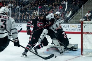 Omaha Maverick Zach Urdahl trying for the puck during a hockey match at Baxter Arena on Saturday, January 25, 2025, in Omaha, Nebraska. Photo by Collin Stilen.