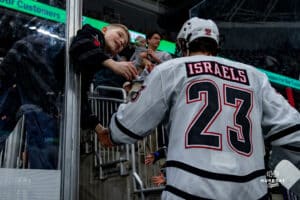 Omaha Maverick Harrison Israels greeted by fan during a hockey match at Baxter Arena on Saturday, January 25, 2025, in Omaha, Nebraska. Photo by Collin Stilen.