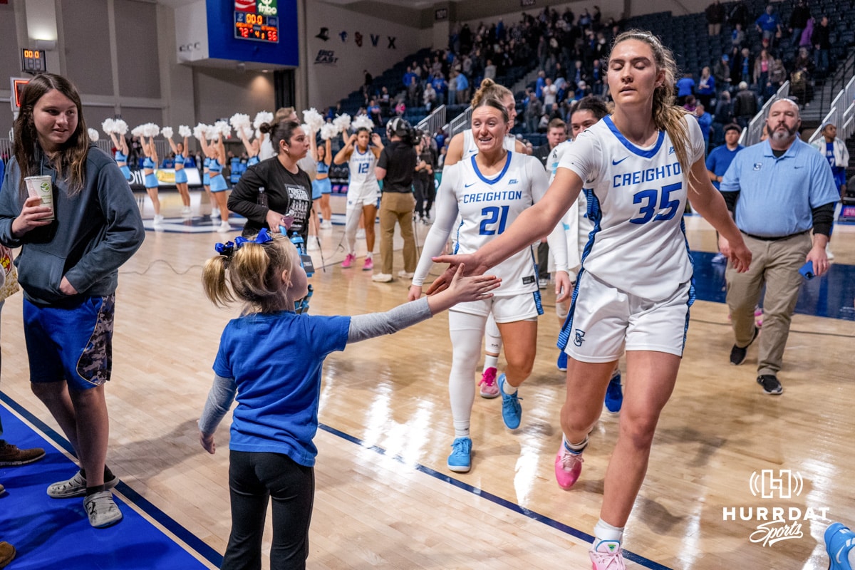 Creighton Bluejays Elizabeth Gentry high fives a young fan after the win over Seton Hall during a college basketball game on February 5, 2025, in Omaha, Nebraska. Photo by Brandon Tiedemann.