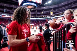 Nebraska Cornhuskers assistant Josiah Allick signs an autograph before a college men’s basketball game a on Sunday, February 9, 2025 in Lincoln, Nebraska. Photo by John S. Peterson.