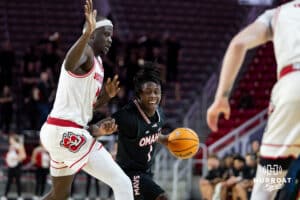 Omaha Mavericks guard JJ White (1) dribbles the ball against South Dakota Coyotes forward Mayuom Buom (0) in the first half during a college basketball game, Wednesday, January 29, 2025, in Vermillion, South Dakota. Photo by John S. Peterson.