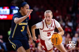 Nebraska Cornhuskers guard Alberte Rimdal (5) dribbles the ball against Michigan Wolverines guard Mila Holloway (3) in the second quarter during a college women’s basketball game on Wednesday, February 6, 2025 in Lincoln, Nebraska. Photo by John S. Peterson.