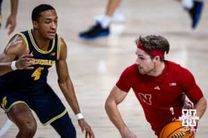 Nebraska Cornhusker guard Sam Hoiberg (1) dribbles the ball against Michigan Wolverine guard Nimari Burnett (4) in the first half during a college men’s basketball game Monday, February 24, 2025 in Lincoln, Nebraska. Photo by John S. Peterson.