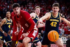 Nebraska Cornhusker forward Berke Buyuktuncel (9) and Michigan Wolverine forward Will Tschetter (42) go after the ball in the first half during a college men’s basketball game Monday, February 24, 2025 in Lincoln, Nebraska. Photo by John S. Peterson.