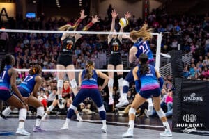 Omaha Supernovas Emily Londot (27) spikes the ball against Columbus Fury Maley Rammelsberg (18) and Megan Courtney-Lush (17) during a professional volleyball match, Friday, January 31, 2025, in Omaha, Nebraska. Photo by John S. Peterson