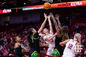 Nebraska Cornhusker guard Alberte Rimdal (5) makes a layup against Oregon Duck forward Amina Muhammad (5) and forward Sarah Rambus (23) in the fourth quarter during a college women’s basketball game Wednesday, February 19, 2025 in Lincoln, Nebraska. Photo by John S. Peterson.